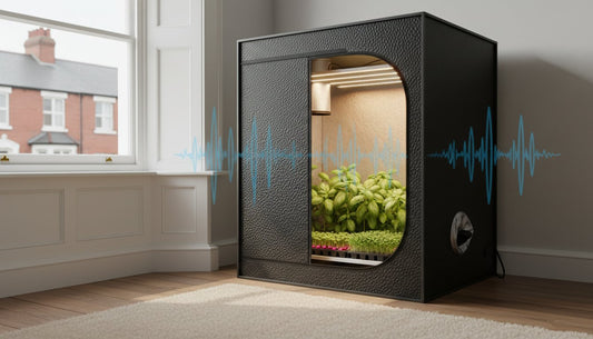 Compact black hydroponic grow box with integrated lighting and green plants inside.