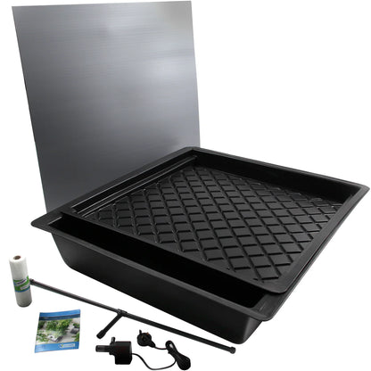 Black plastic tray with grid pattern, metal sheet, and small items on a white background