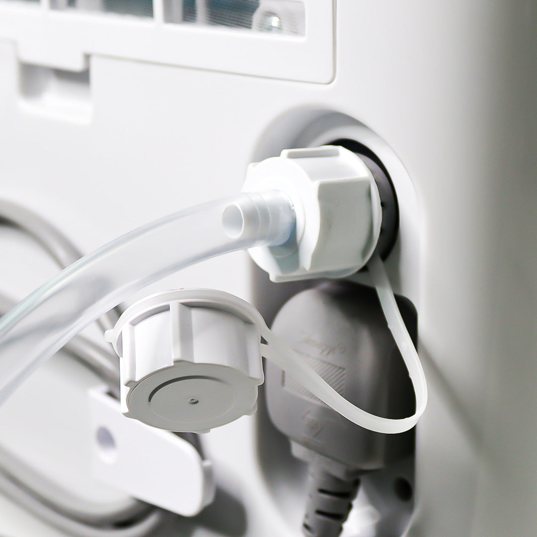 Close-up of medical equipment with tubing and connectors on a white background