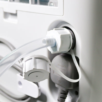 Close-up of medical equipment with tubing and connectors on a white background