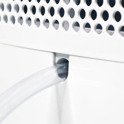 Close-up of a white electronic device with a perforated cover