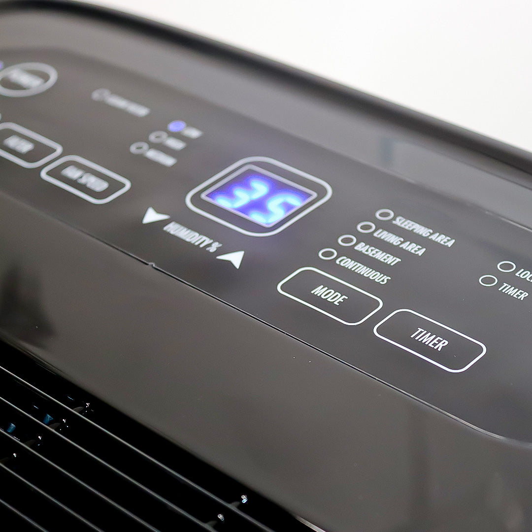 Control panel of an air conditioner with digital display and buttons.