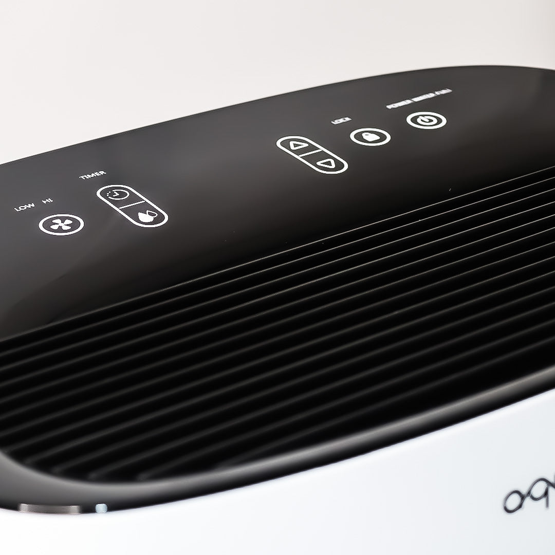 Black air purifier with control panel on a white background