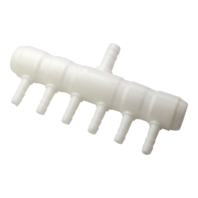 White plastic component with multiple nozzles on a white background