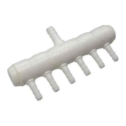 White plastic component with multiple small pipes on a white background