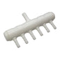 White plastic component with multiple small pipes on a white background
