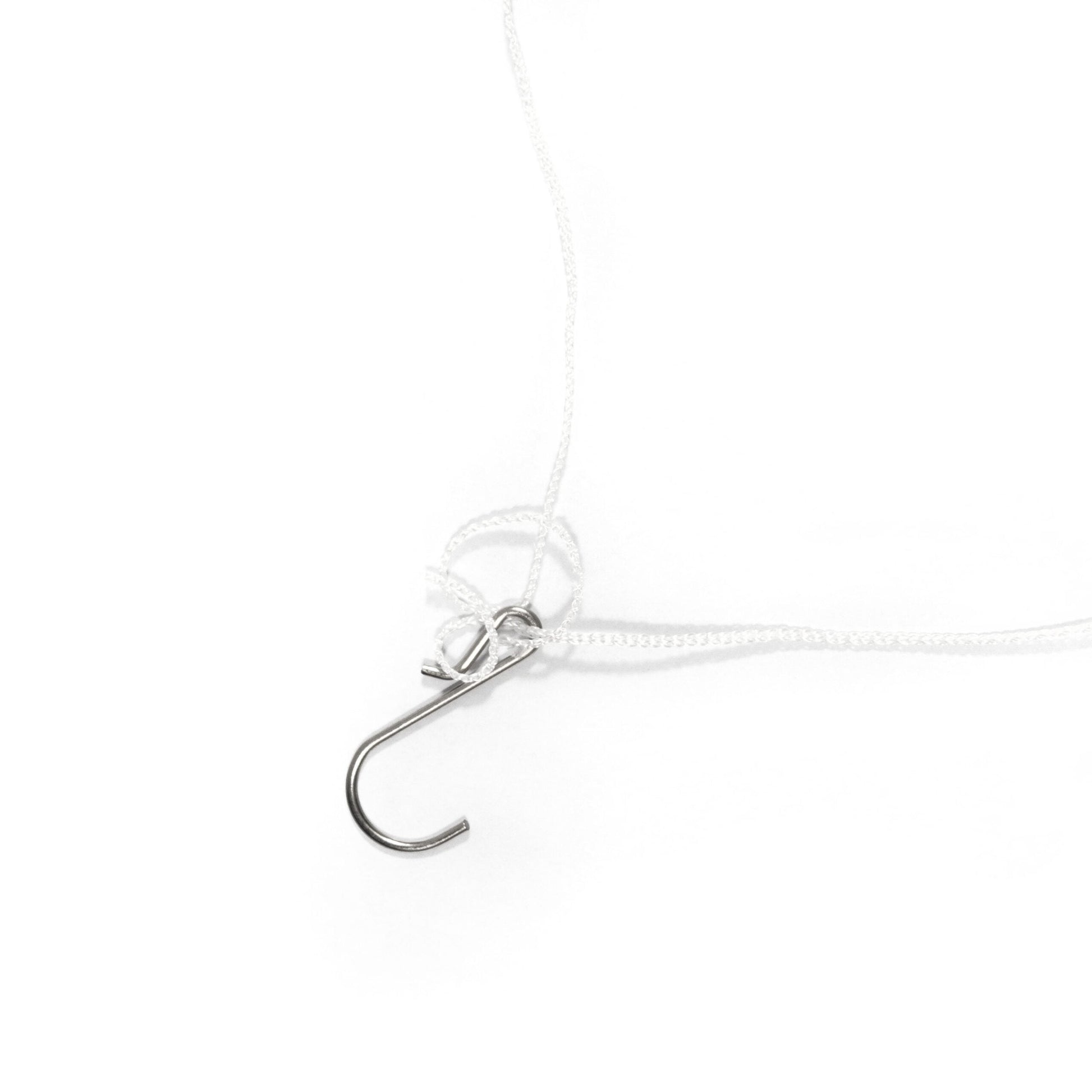 Close-up of a silver hook on a white background