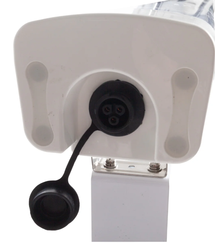 Close-up of a white electronic device with black connectors on a white background