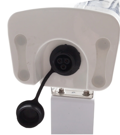 Close-up of a white electronic device with black connectors on a white background