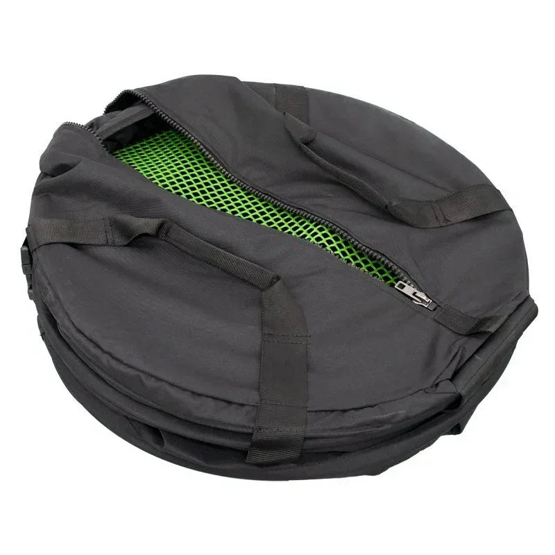 Black circular carrying bag with handles, partially open to reveal a green mesh interior.